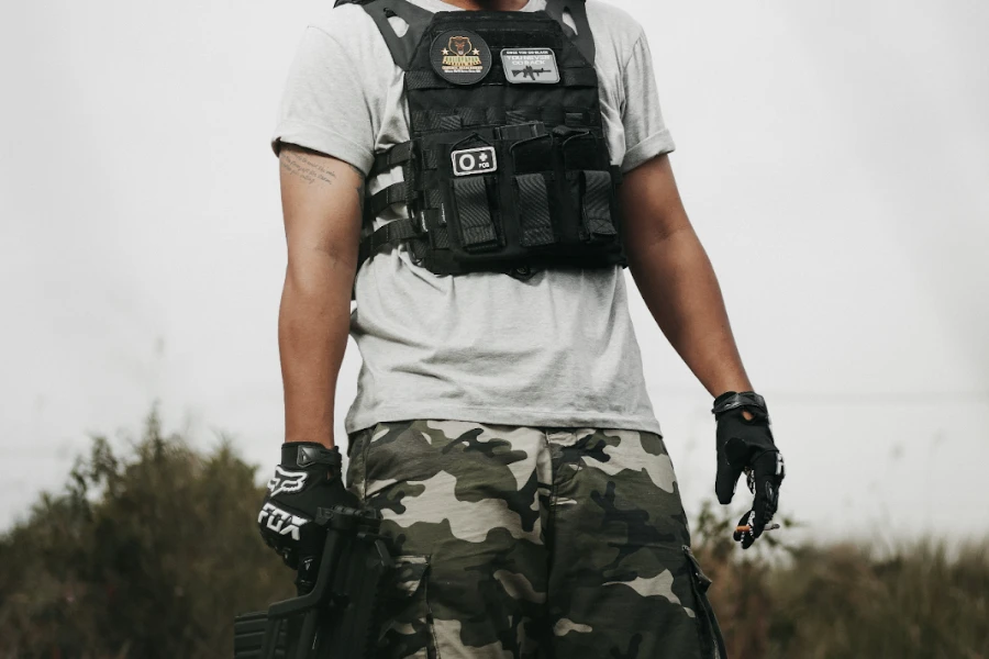 Man posing in a multiple pocket tactical vest