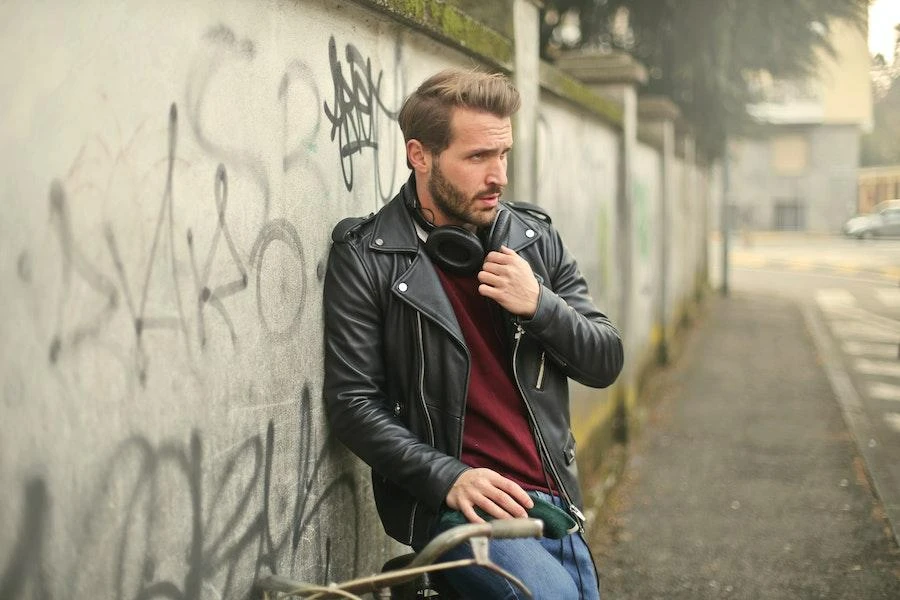 Man posing in a street rocking a stylish leather jacket