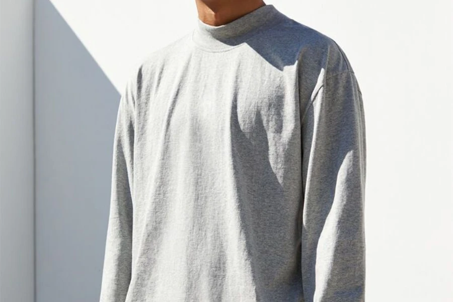 Man rocking a gray long-sleeved solid-colored tee