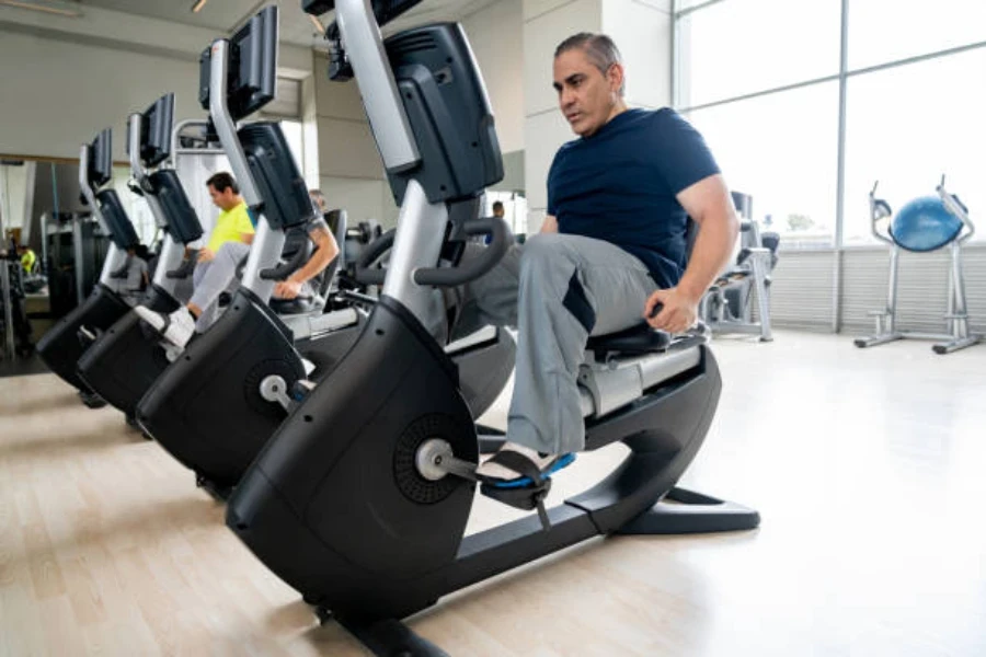 Man sitting on recumbent bike with handles on the side