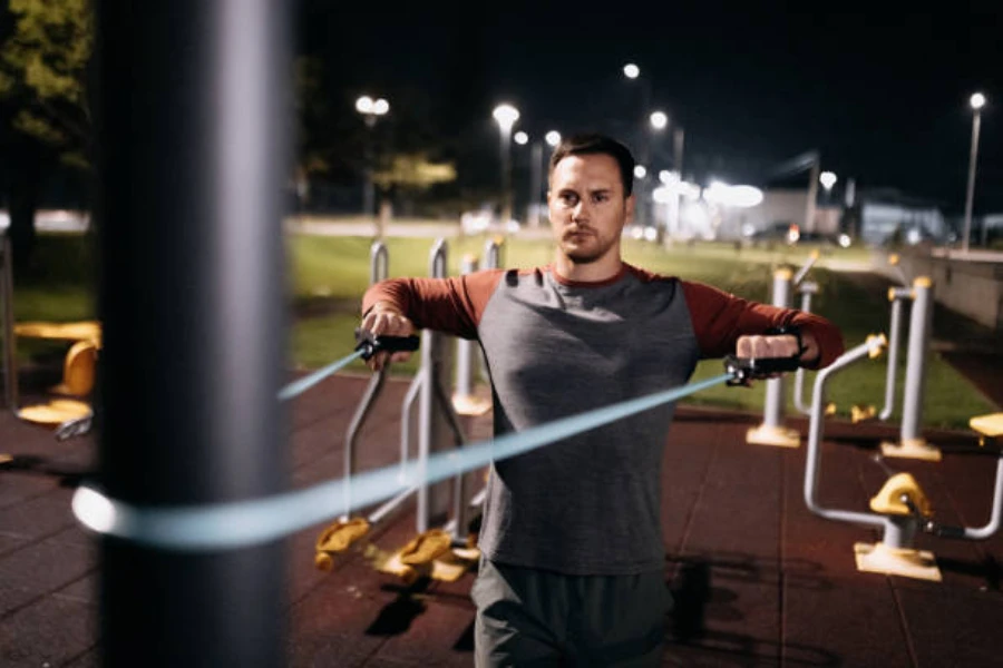 Man using fabric resistance band during outdoor workout