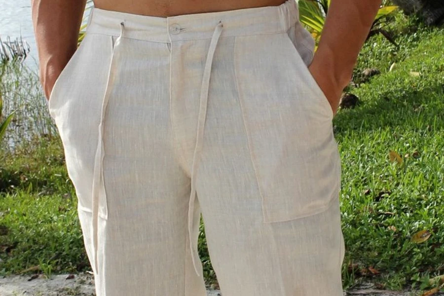 Мужчина с руками в карманах классических льняных брюк