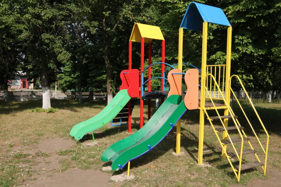 Outdoor playground with multiple slide types coming from it