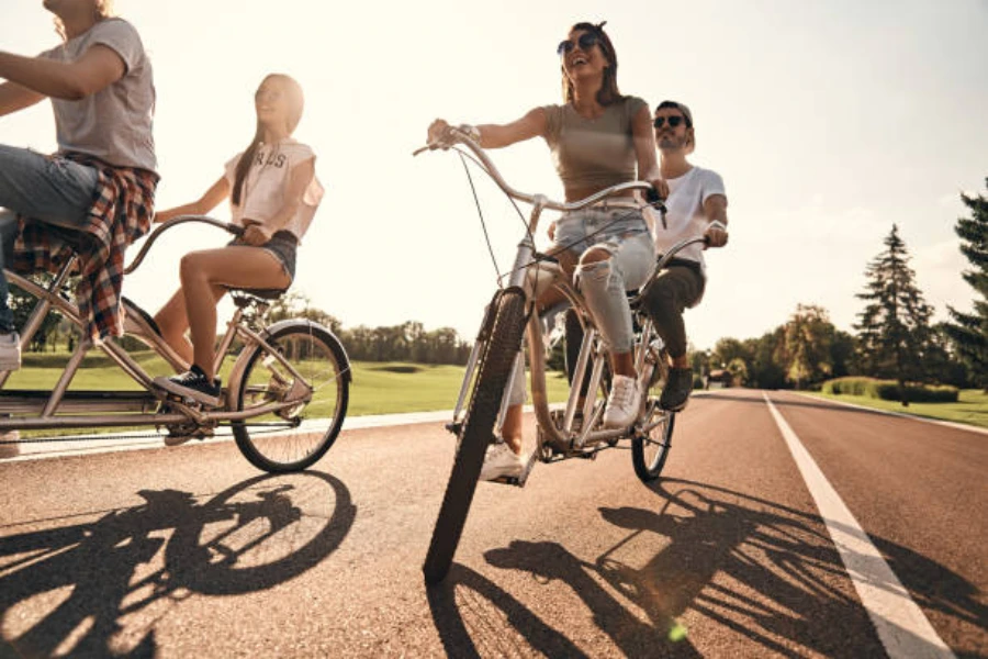Pair of tandem bikes being used by four friends