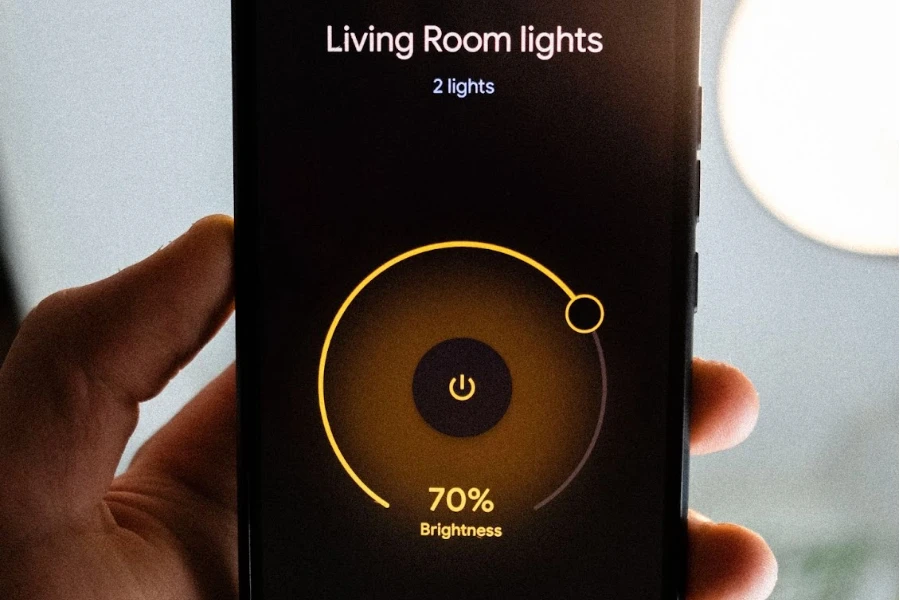 Person controlling living room lights on a smartphone