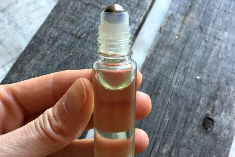 Person showcasing a bottle of cuticle oil