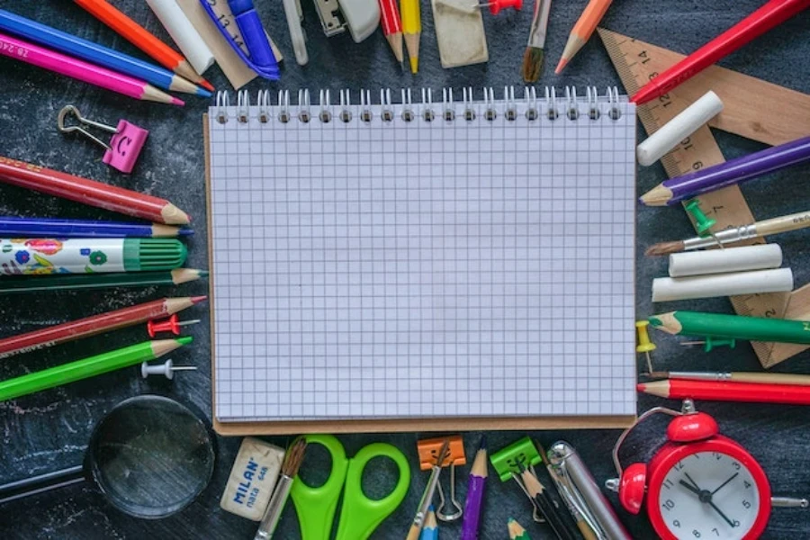 School stationery, including notebook, pens, pins, tape