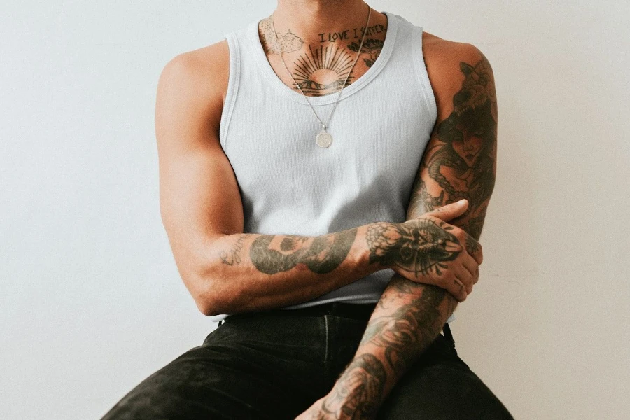 Tattooed man donning a gray tank top
