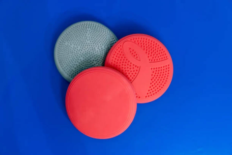 Three colorful balance bads laying on blue background