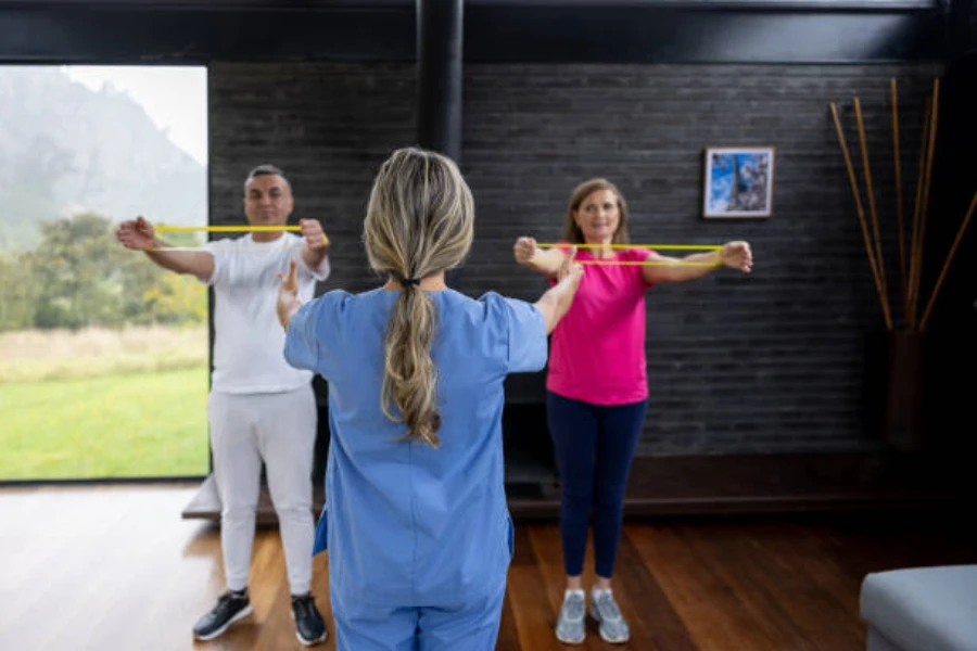 Two clients using resistance band in rehabilitation program