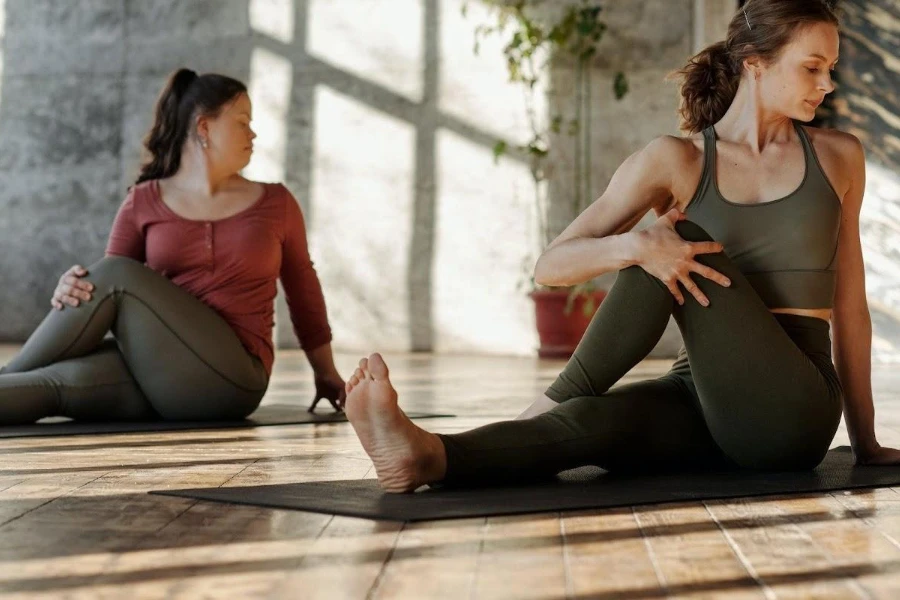 Two women in earth-colored leggings during a workout