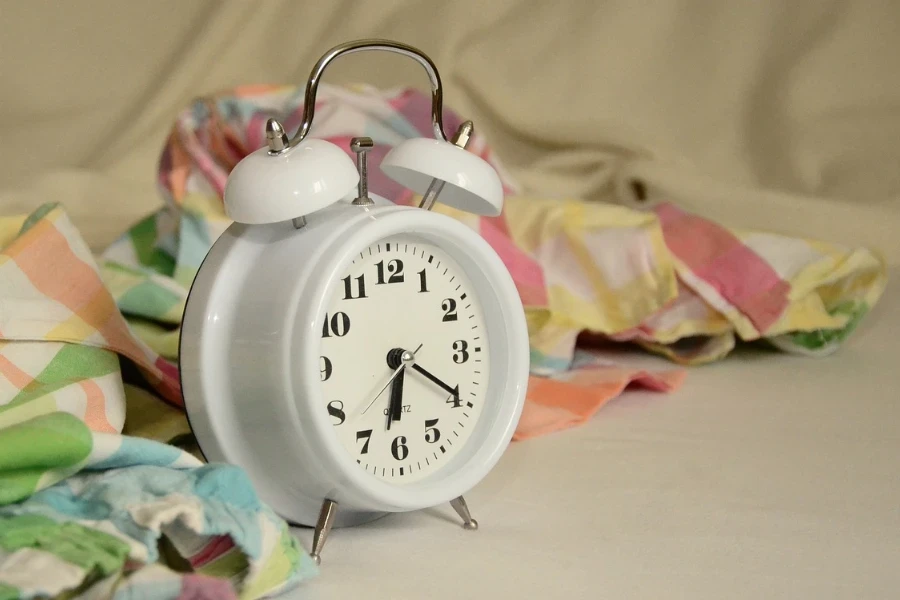 white alarm clock on table