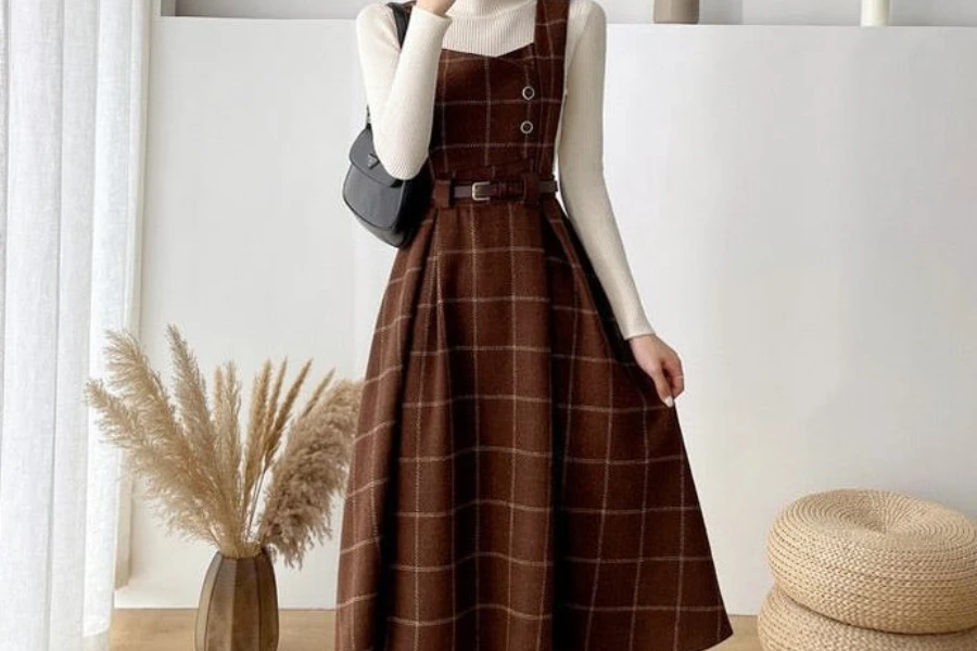 Woman dressed in a brown plaid apron dress