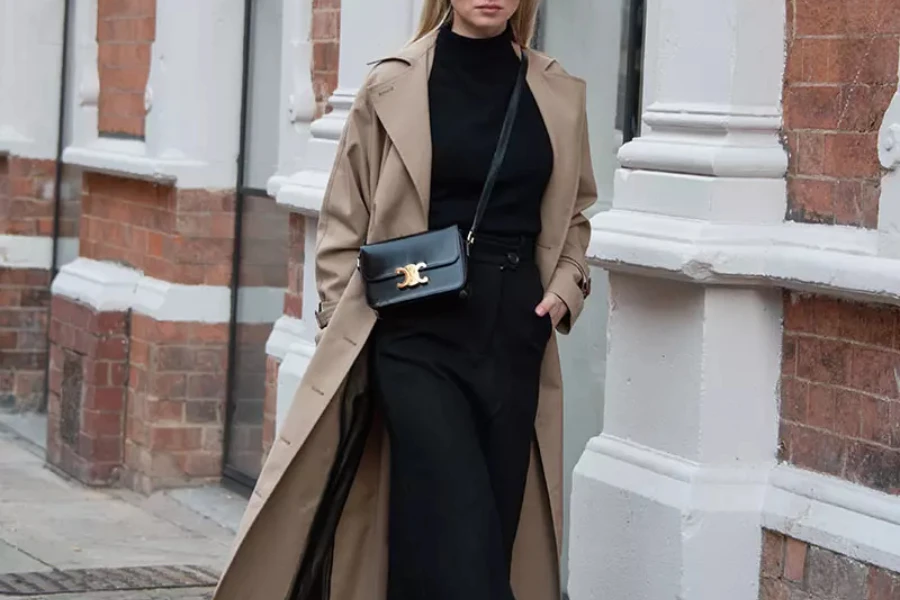 Woman dressed in tailored trench coat and monochromatic outfit