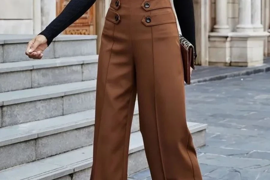 Woman holding a purse and rocking tailored pants