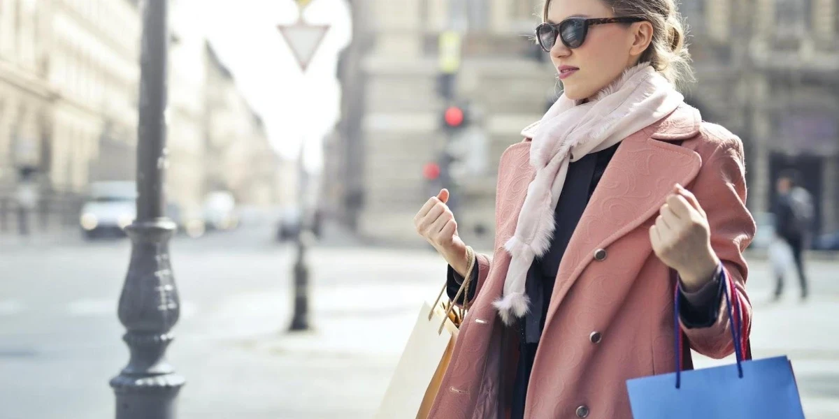 Woman in a pink oversized jacket and pink neck scarf