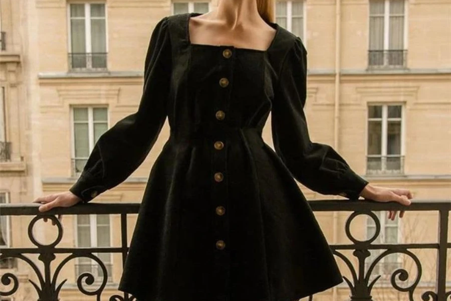 Woman on a balcony dressed in a black long-sleeved dress