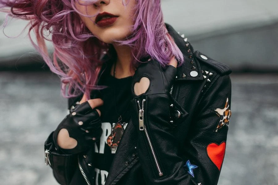Woman posing in a detailed black leather jacket