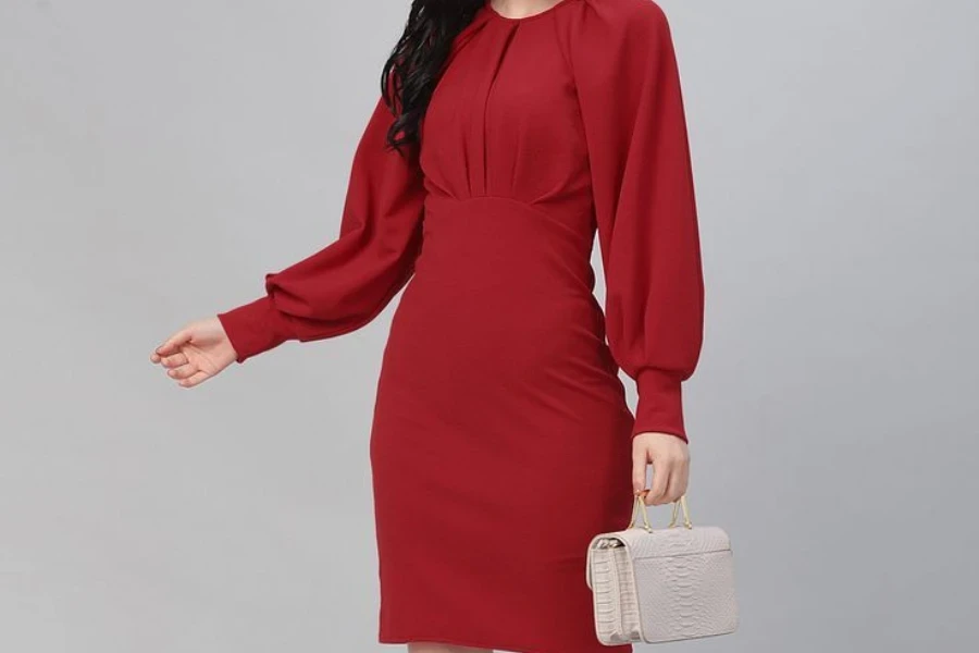 Woman posing in a red monochromatic sheath dress