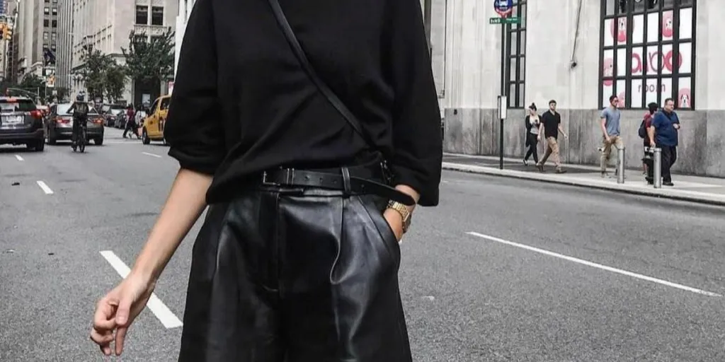 woman posing in an all-black scandinavian outfit
