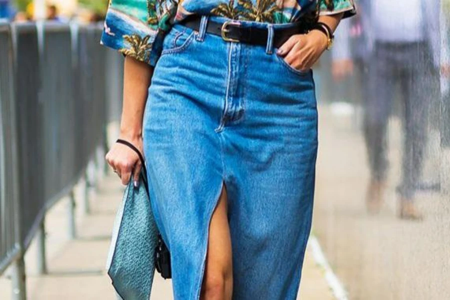 Woman putting hands in the pocket of a denim skirt