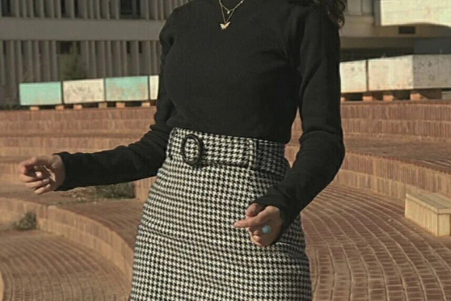 Woman rocking a black blouse and patterned mini skirt