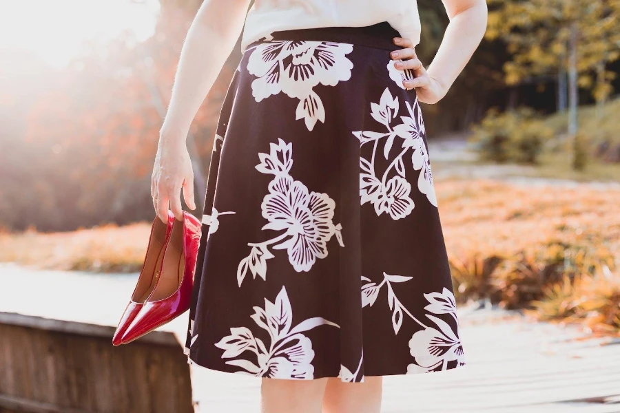 Woman wearing a black, floral patterned full skirt