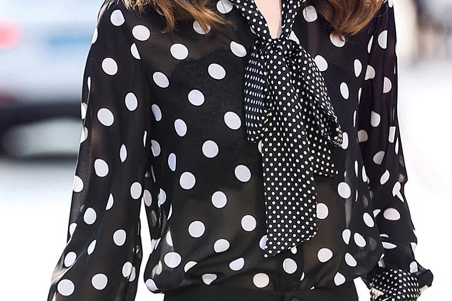Woman wearing a sheer polka dot blouse