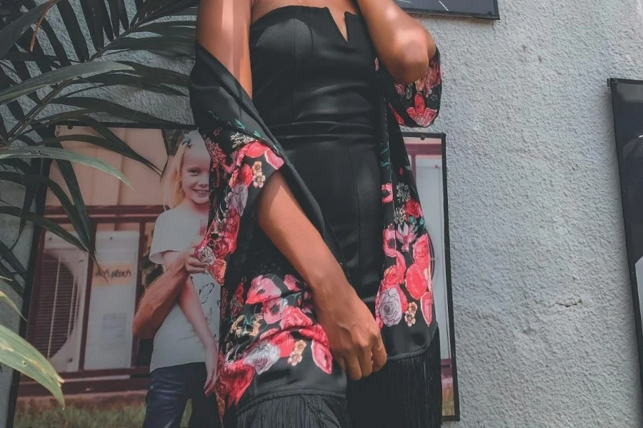 Woman wearing a silky dark floral dress and shaul