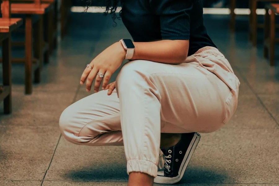 Woman wearing pink joggers while squatting