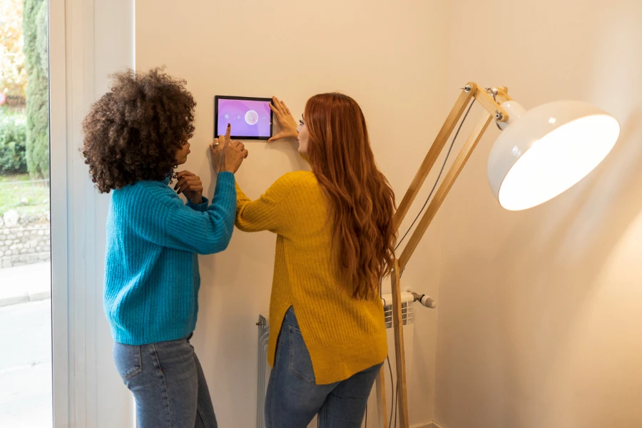 Couple setting up a smart thermostat