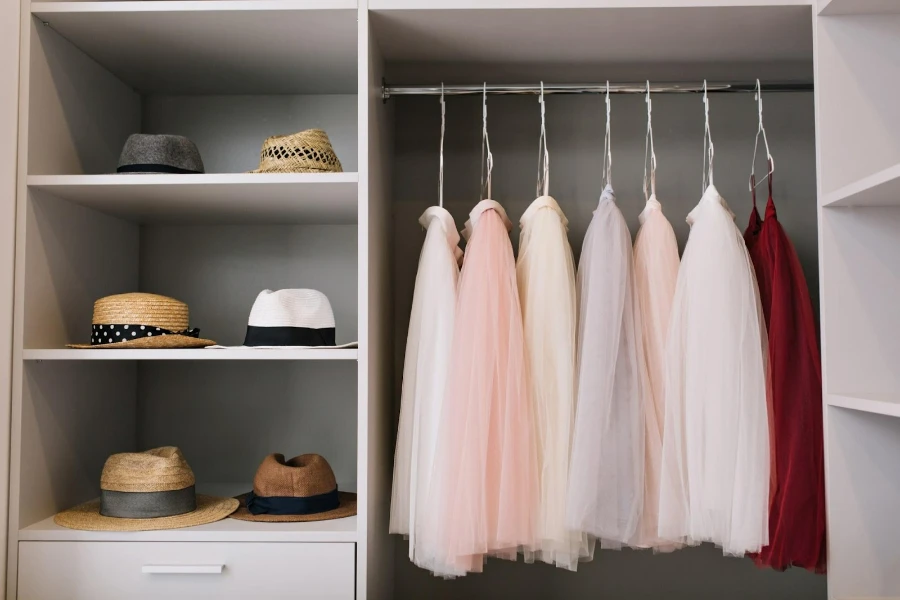 A closet with hanging and compartment organizers