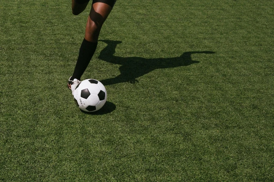 A match ball in play on a green pitch