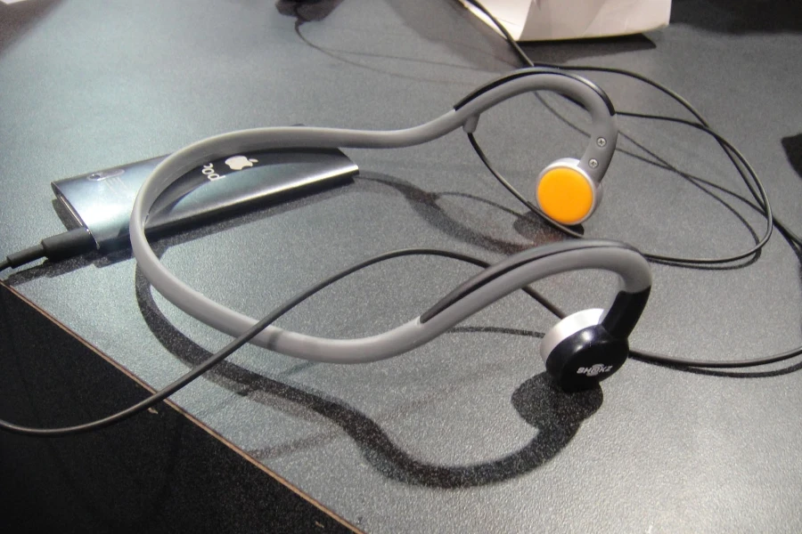 A pair of gray bone conduction headphones on a table