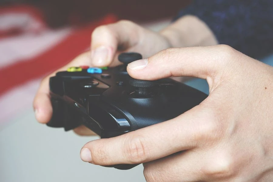 A person using a black game controller