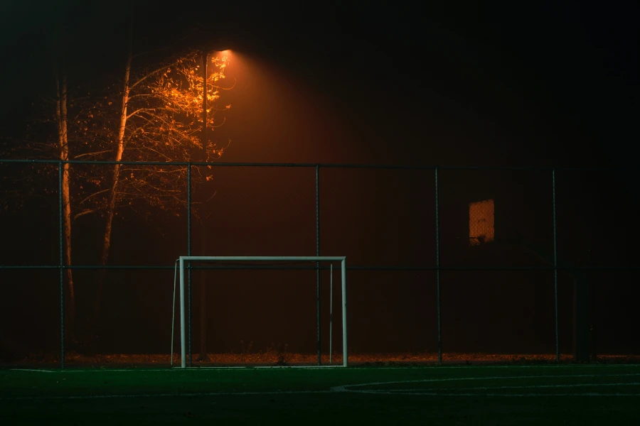 A portable goal on a training field at night