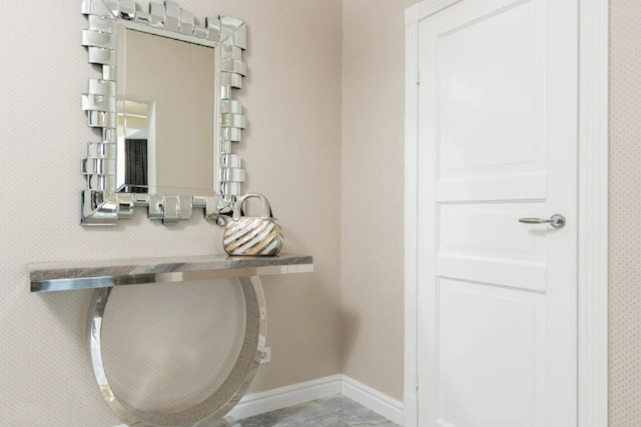 A square silver-lined mirror placed above a console