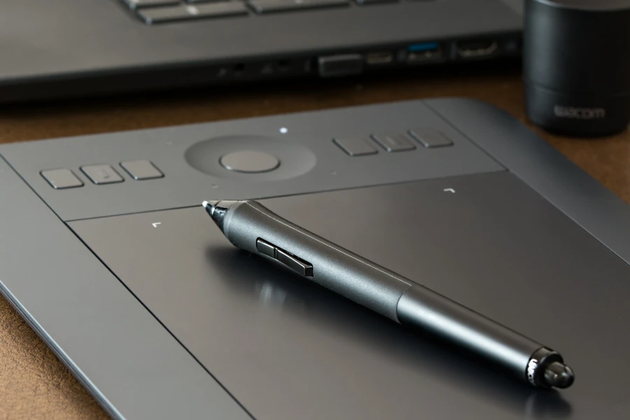 A stylus pen resting on a drawing tablet