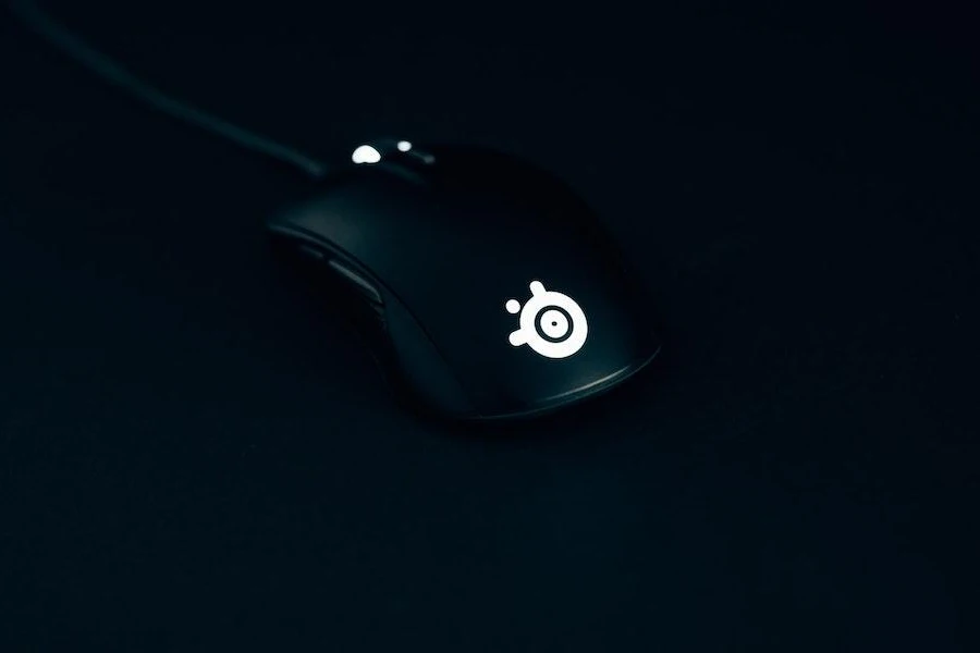 A wired gaming mouse with a glowing logo