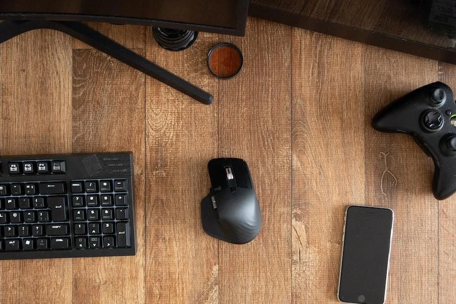 A wireless gaming mouse with other devices on a table