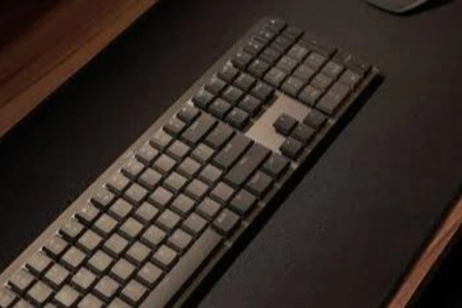 A wireless keyboard on a black table