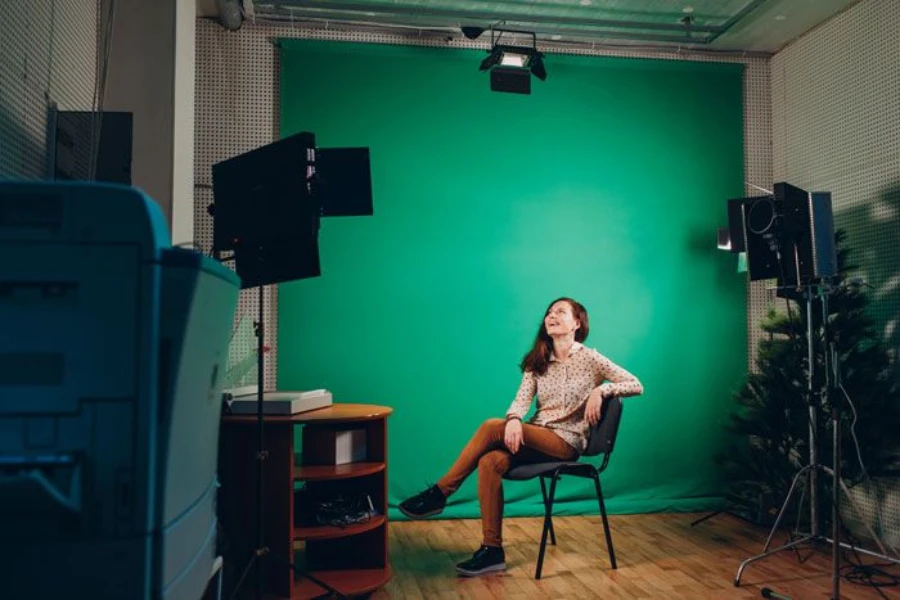 A woman streaming while using a green screen