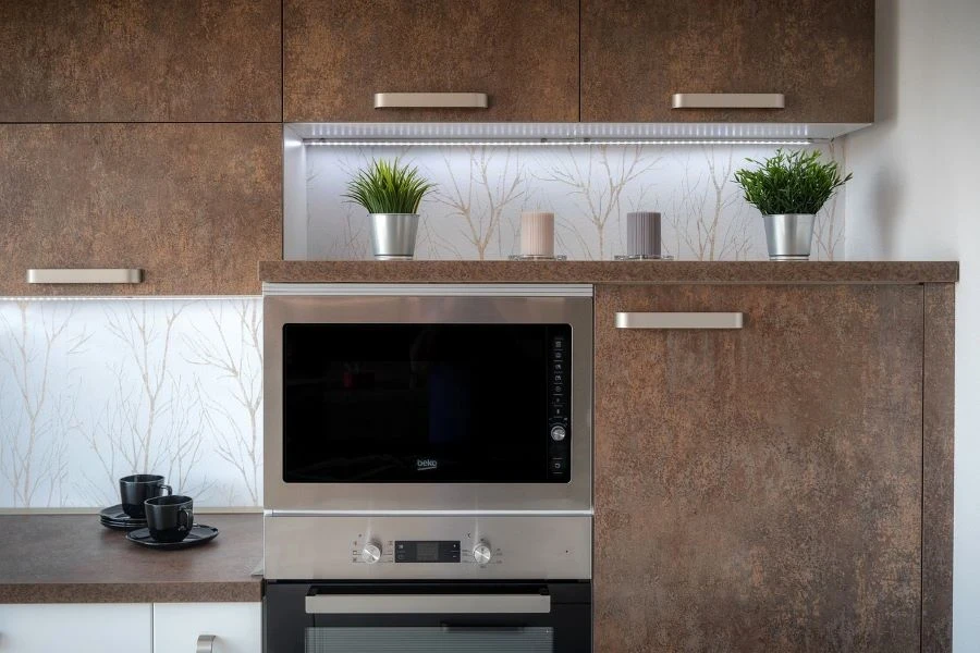 An oven surrounded by brown cabinets