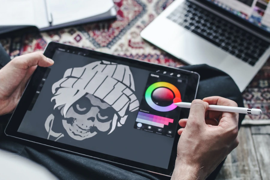 Artist drawing on a tablet with a white stylus pen
