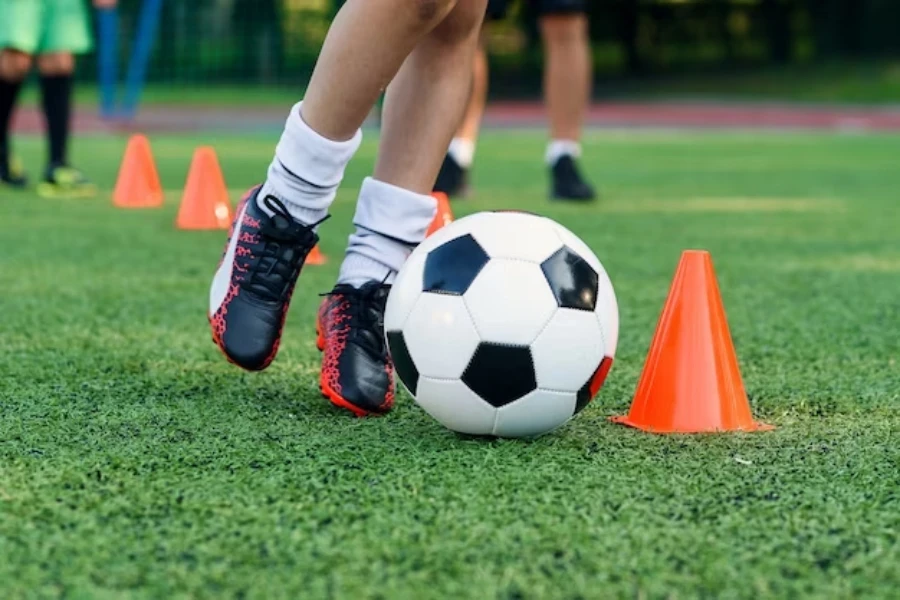 Athlete training with mini cones on a field