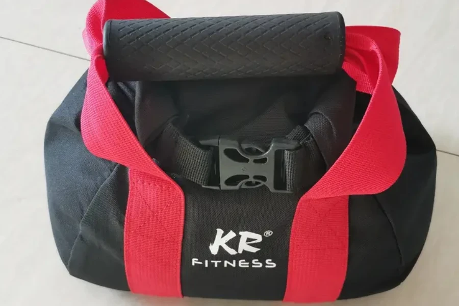 Black kettlebell sandbag with red strap around body