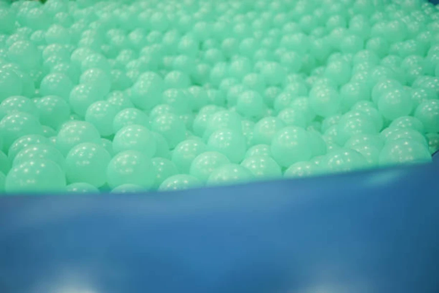Blue ball pit with green glow in the dark balls