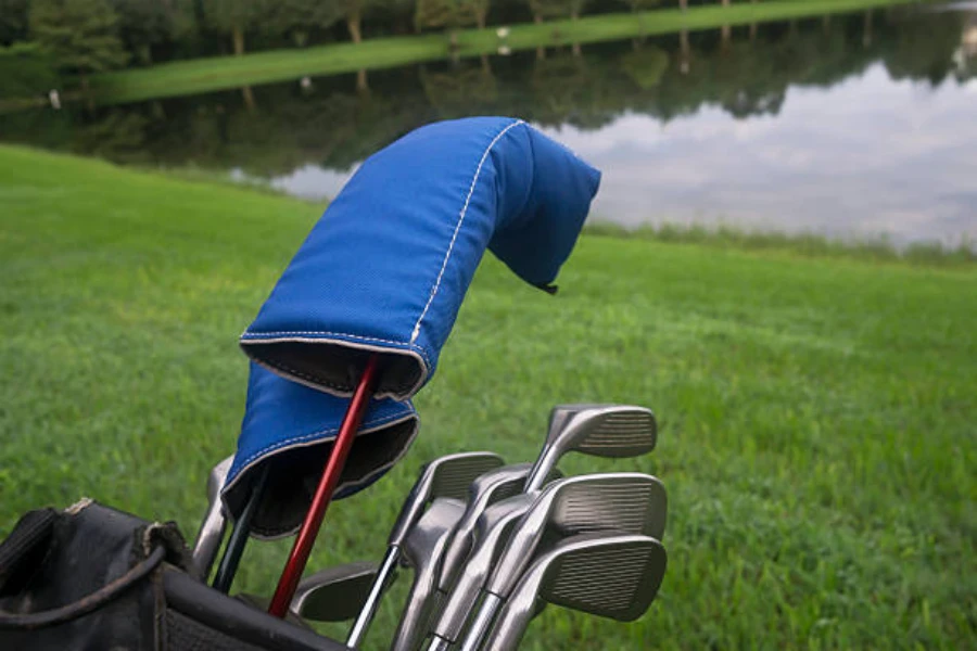 Blue fabric head cover on top of drivers in bag