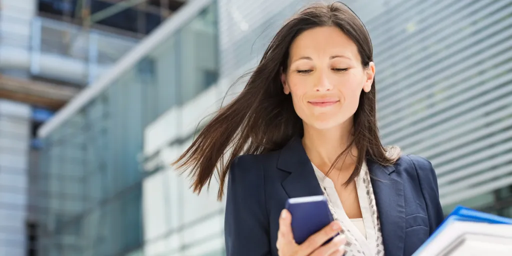 businesswoman using cell phone in office