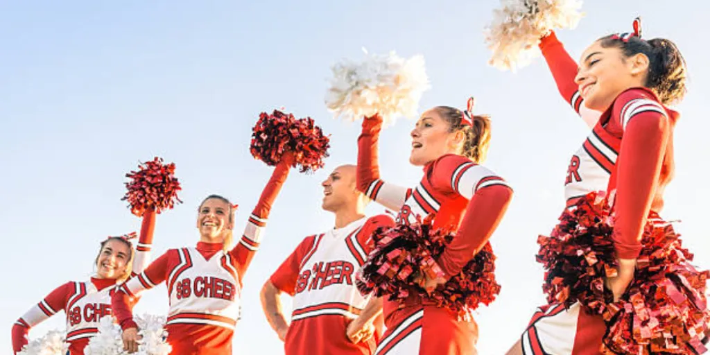 Cheer squad in white and red with matching pom poms